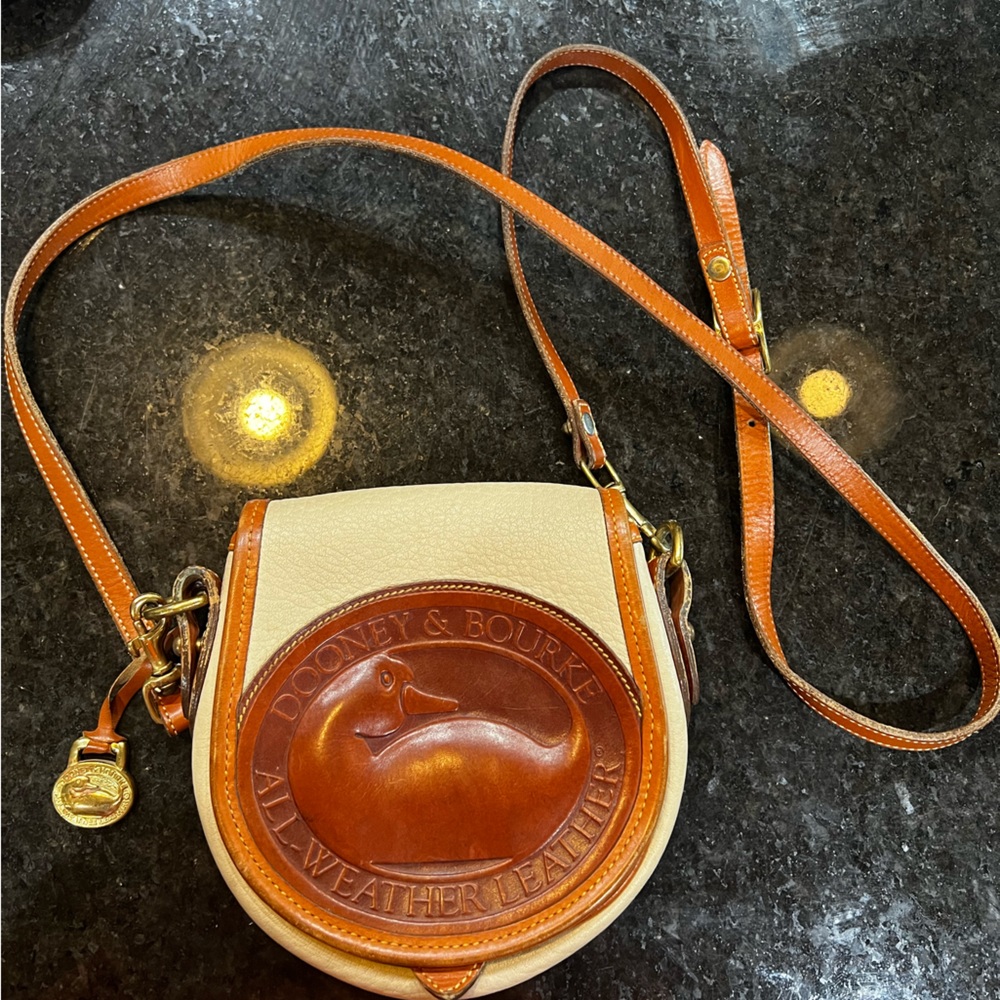 Vintage genuine leather Dooney and Bourke mini cross body bag.